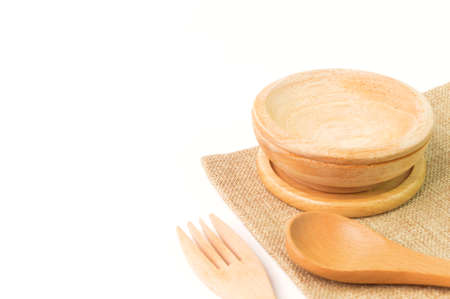 Side view of wooden cutlery utensil (fork,spoon and plate) isolated on a white background