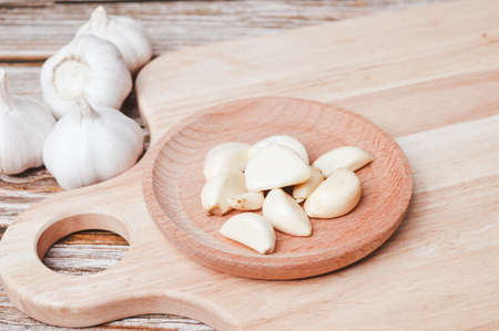 Fresh garlic on wooden plate. Garlic is a species in the onion genus, Allium. Selective focus.の写真素材