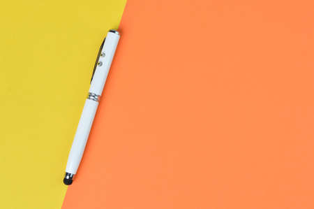 Top view of white pen over yellow and orange background with copy space. Business conceptの写真素材