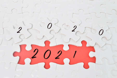 Jigsaw puzzle with number 2020 and 2021. Concept of transit from 2020 to 2021.
