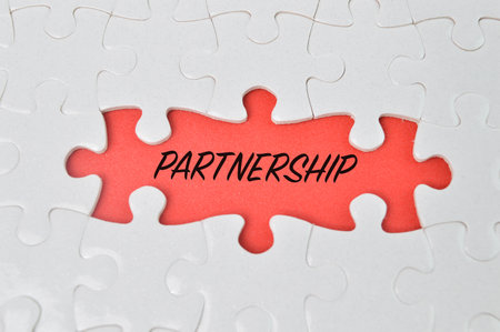 Jigsaw puzzle with word PARTNERSHIP. Business concept.の写真素材