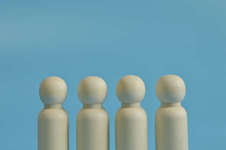 Wooden figures of people in a row. Teamwork concept.の写真素材