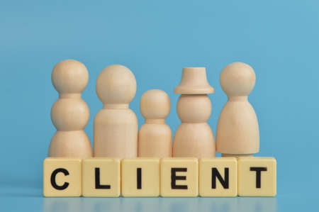 Wooden doll figures and alphabet letters with text CLIENT. Business concept.の写真素材