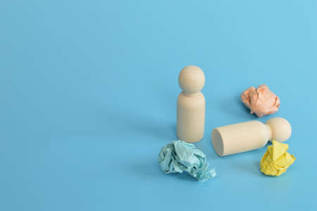 Wooden doll figures and paper waste. Concept of psychological stress and pressure.の写真素材
