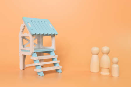 Family doll figures standing in front of the new house