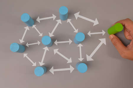 Hand picked a green wooden block. Organisation structure, teamwork and social network concepts.の写真素材