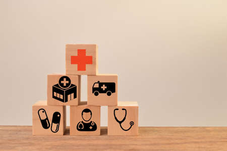 Conceptual of healthcare. Wooden cube blocks with healthcare iconsの写真素材