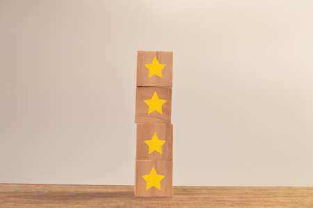Wooden blocks with yellow stars. Excellent business services rating customer experience concept.の写真素材