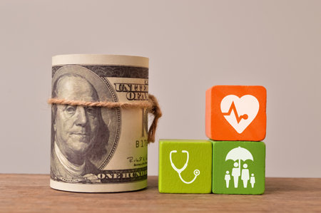 Life insurance concept. Money banknote with stethoscope, heart and family iconsの写真素材