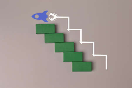 Wooden cube blocks with launching rocket. Business start up, new idea and new project concept.の写真素材