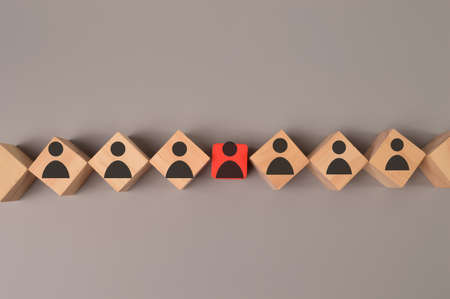 Red wooden block with person icon. Leadership, different views and individuality concept.