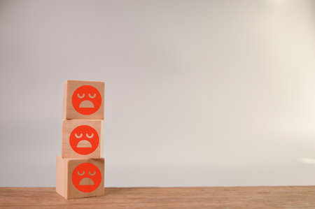 sad face wooden blocks in a row. Customer evaluation and satisfaction concept.の写真素材