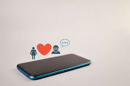 Smartphone with scammer, love and wooden iconsの写真素材