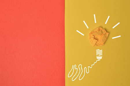 Light bulb isolated on a yellow backgroundの写真素材