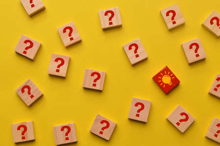 Light bulb and question mark icon drawn on wooden blocksの写真素材