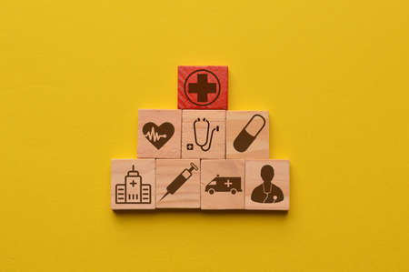Conceptual of healthcare. Wooden cube blocks with healthcare icons.の写真素材