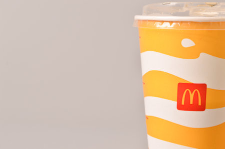 Klang, Malaysia: June 24, 2021- McDonald's soft drink in paper cup isolated on grey background. Copy space.のeditorial素材