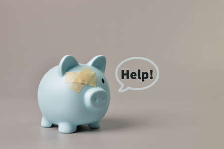Piggy bank and band aids with text HELP. Copy spaceの写真素材
