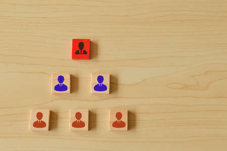Image of people symbols on wooden blocks. Building a strong team, human resources and management concept.の写真素材