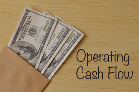Money banknotes on the table with text OPERATING CASH FLOWの写真素材