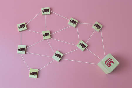 Wooden blocks with truck icons linked to each other to the store. Logistic, delivery and cargo concept.の写真素材