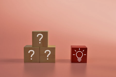 Wooden block with question marks and light bulb symbol