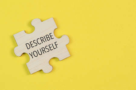Wooden jigsaw puzzle with phrase DESCRIBE YOURSELFの写真素材