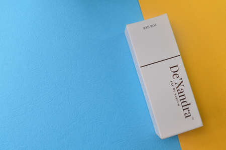 Klang, Malaysia: August 4, 2021- De'Xandra perfume box isolated on yellow and blue background