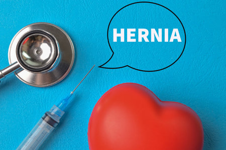 Stethoscope and red heart shape with text HERNIAの写真素材