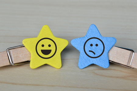 Wooden clip with happy and sad face emotion. Customer feedback, evaluation and satisfaction concept