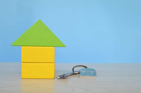 Toy wooden house and key. Real estate and property conceptの写真素材