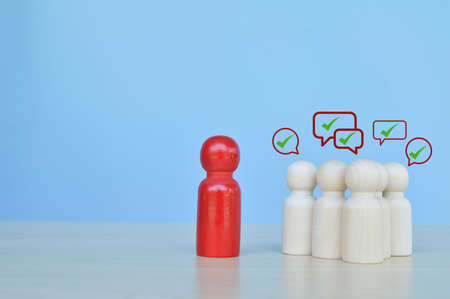 Wooden doll figures with green mark icons. Voting and election conceptの写真素材