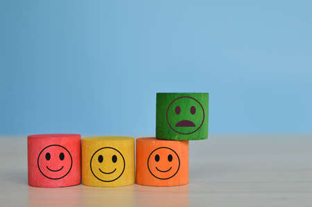 Wooden cube block with different face expression. Customer feedback and evaluation concept.の写真素材