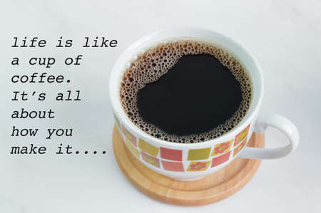 A cup of coffee with text LIFE IS LIKE A CUP OF COFFEE. IT'S ALL ABOUT HOW YOU MAKE ITの写真素材