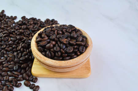 Coffee bean brown roasted on wooden plate. Selective focusの写真素材