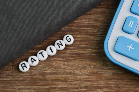 Notebook, calculator and alphabet beads with text RATING.の写真素材
