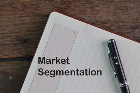 Pen and notebook written with text MARKET SEGMENTATIONの写真素材