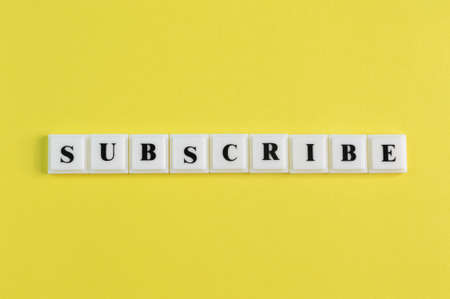 Square letters with text SUBSCRIBE isolated on a yellow backgroundの写真素材