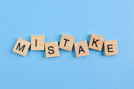 Wooden square letters with text MISTAKE. Top viewの写真素材