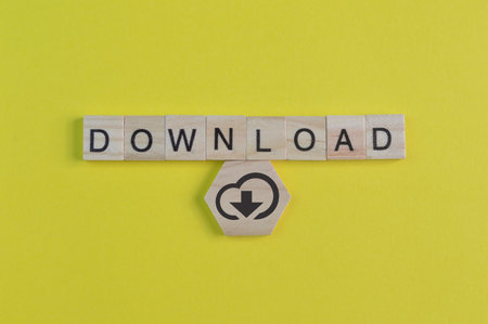 Square letters with text download isolated on a yellow backgroundの写真素材