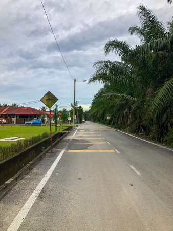 Straight empty road with cloudy sky. Selective focus