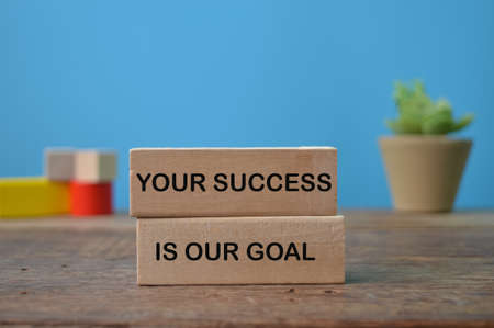 Wooden block written with YOUR SUCCESS IS OUR GOALの写真素材