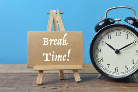 Alarm clock and brown card written with BREAK TIME!の写真素材