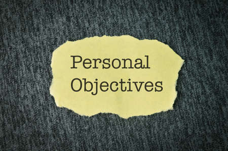 Yellow torn paper written with text PERSONAL OBJECTIVES