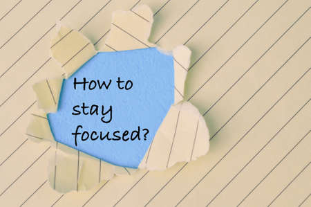 Torn paper written with question HOW TO STAY FOCUSED?の写真素材