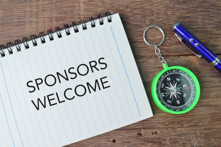 Pen, compass and notebook written with text SPONSORS WELCOMEの写真素材