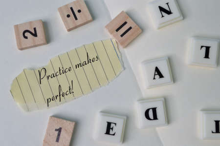 Torn paper written with text PRACTICE MAKES PERFECT!の写真素材