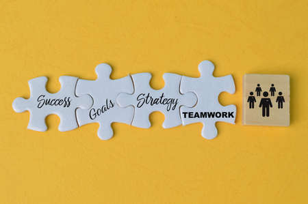 Jigsaw puzzle with text SUCCESS, GOALS, STRATEGY and TEAMWORKの写真素材