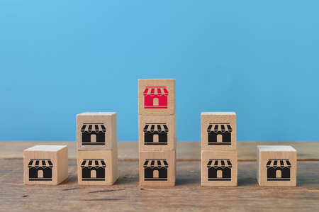 Wooden cube blocks with store symbols. Franchise marketing system conceptの写真素材