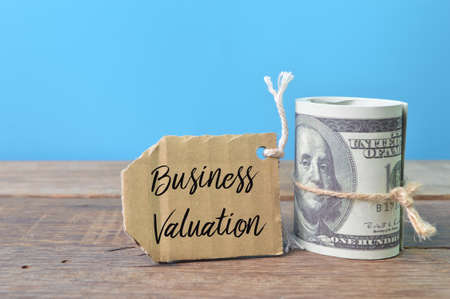 Money banknotes and label tag written with text BUSINESS VALUATIONの写真素材